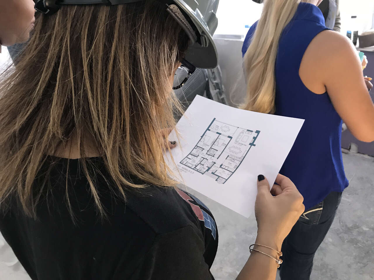 A student holding a floor plan of Harbor Verandas